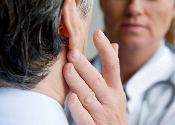 Doctor feeling patient's neck